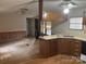 Open kitchen and living space with wooden cabinets, laminate countertops, and standard white appliances at 3748 Caribou Dr, Sherrills Ford, NC 28673