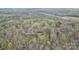 Expansive aerial view of a red brick home nestled in a lush, green wooded area near a quiet road at 3772 Sandy Ford Rd, Hickory, NC 28602