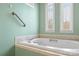 Close up of bathroom with soaking tub and natural light from dual windows at 3772 Sandy Ford Rd, Hickory, NC 28602