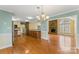 Dining area with chandelier, stainless steel appliances, hardwood floors, view to the living room and fireplace at 3772 Sandy Ford Rd, Hickory, NC 28602