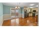 Dining area with hardwood floors, stainless appliances, view to porch, and bright natural light at 3772 Sandy Ford Rd, Hickory, NC 28602
