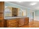 Kitchen with tiled countertop, hardwood floors, and direct view into living room with stone fireplace at 3772 Sandy Ford Rd, Hickory, NC 28602
