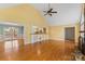 Spacious living room features a stone fireplace, hardwood floors, a ceiling fan and an open floor plan at 3772 Sandy Ford Rd, Hickory, NC 28602