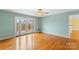 Bright living room featuring hardwood floors, ceiling fan, and access to an outdoor deck at 3772 Sandy Ford Rd, Hickory, NC 28602