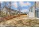 Landscaped backyard with a brick patio, privacy fence, and view of neighboring homes at 4241 Black Ct # 198, Harrisburg, NC 28075