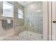 Luxurious marble tiled walk-in shower with a built-in bench and glass door at 4241 Black Ct # 198, Harrisburg, NC 28075