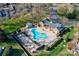 Aerial view of a community pool and lounge area with lush landscaping and manicured lawns at 4351 Woodglen Ln, Charlotte, NC 28226