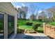 Scenic backyard featuring mature landscaping, green grass, and a peaceful patio area at 4351 Woodglen Ln, Charlotte, NC 28226