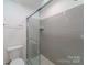 Modern bathroom features tiled shower, glass door, and updated fixtures at 4351 Woodglen Ln, Charlotte, NC 28226