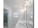Bright bathroom featuring double sinks, modern fixtures, and a glass-enclosed shower for a spa-like experience at 4351 Woodglen Ln, Charlotte, NC 28226