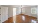 Bright bedroom with hardwood floors, ceiling fan, and windows with charming shuttered accents at 4351 Woodglen Ln, Charlotte, NC 28226