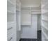 Spacious walk-in closet with ample shelving and storage, highlighted by sleek, dark flooring at 4351 Woodglen Ln, Charlotte, NC 28226
