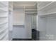 Walk-in closet featuring custom shelving and a dark floor at 4351 Woodglen Ln, Charlotte, NC 28226