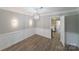 Elegant dining room featuring modern floors, wainscoting, and a stylish chandelier, ideal for memorable dining experiences at 4351 Woodglen Ln, Charlotte, NC 28226