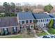 A row of townhomes featuring brick facades, dark shutters, and well-maintained front lawns at 4351 Woodglen Ln, Charlotte, NC 28226