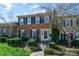 Charming two-story brick home featuring black shutters and well-manicured landscaping, offering timeless curb appeal at 4351 Woodglen Ln, Charlotte, NC 28226