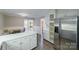 Open kitchen with white cabinets, stainless steel appliances, and a breakfast nook, creating a bright and inviting space at 4351 Woodglen Ln, Charlotte, NC 28226