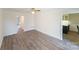 Spacious living room with hardwood floors, ceiling fan, and access to kitchen and bedroom at 4351 Woodglen Ln, Charlotte, NC 28226