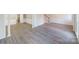 Open-concept living room showcasing modern floors, wainscoting, and a staircase, perfect for entertaining guests at 4351 Woodglen Ln, Charlotte, NC 28226