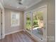 Sunlit sun room featuring French doors leading to a patio, offering a serene space to relax and enjoy the outdoors at 4351 Woodglen Ln, Charlotte, NC 28226