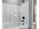 A bright bathroom with a white tub and black fixtures at 437 Cedar Grove Rd, Clover, SC 29710
