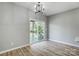 The dining area features an elegant chandelier and sliding glass doors to a deck at 437 Cedar Grove Rd, Clover, SC 29710