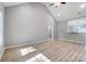 Bright living room with vaulted ceilings, sleek vinyl flooring, and a pass through to the kitchen at 437 Cedar Grove Rd, Clover, SC 29710