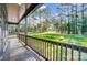 Spacious covered porch with wooden railing, offering serene views of the surrounding trees and landscape at 437 Cedar Grove Rd, Clover, SC 29710