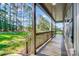Spacious covered porch with wooden railing, offering serene views of the surrounding trees and landscape at 437 Cedar Grove Rd, Clover, SC 29710