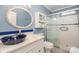 Modern bathroom featuring a marble vanity, dark blue accents and a white tiled shower with glass door at 4501 Brandie Glen Rd, Charlotte, NC 28269