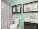 Well-lit bathroom with a single sink vanity, medicine cabinet and a shower with striped shower curtain at 4501 Brandie Glen Rd, Charlotte, NC 28269