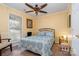 Bright bedroom featuring a ceiling fan, a bed with blue patterned covers, and a large window at 4501 Brandie Glen Rd, Charlotte, NC 28269