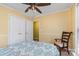 Cozy bedroom featuring a ceiling fan, a bed with blue patterned covers, closet and a small window at 4501 Brandie Glen Rd, Charlotte, NC 28269