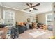 Spacious bonus room filled with assorted items, featuring a ceiling fan and multiple windows at 4501 Brandie Glen Rd, Charlotte, NC 28269