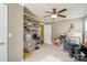 Spacious bonus room filled with assorted items, featuring a ceiling fan, shelves, and a door at 4501 Brandie Glen Rd, Charlotte, NC 28269