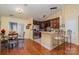 Open kitchen with stainless steel appliances, wooden cabinetry, granite countertops and breakfast bar seating at 4501 Brandie Glen Rd, Charlotte, NC 28269
