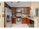 Close up of kitchen with stainless steel appliances, tile backsplash, granite counters and wooden cabinetry at 4501 Brandie Glen Rd, Charlotte, NC 28269