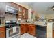 Spacious kitchen with stainless steel appliances, dark cabinetry, tile backsplash, and granite countertops at 4501 Brandie Glen Rd, Charlotte, NC 28269