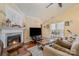 Cozy living room features a fireplace, wood floors, and natural light at 4501 Brandie Glen Rd, Charlotte, NC 28269
