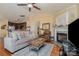 Open-concept living room flowing into the kitchen, featuring a cozy fireplace and hardwood floors at 4501 Brandie Glen Rd, Charlotte, NC 28269