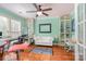 Office/Living Room features hardwood floors, built-in shelving units, and large windows for natural light at 4501 Brandie Glen Rd, Charlotte, NC 28269