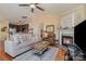 Open-concept living room flowing into the kitchen, featuring a cozy fireplace and hardwood floors at 4501 Brandie Glen Rd, Charlotte, NC 28269