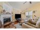 Cozy living room features a fireplace, wood floors, and natural light at 4501 Brandie Glen Rd, Charlotte, NC 28269