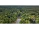 Aerial view of a lakefront home surrounded by a dense forest and shoreline, ideal for nature enthusiasts at 463 Lake Wylie Rd, Belmont, NC 28012