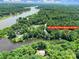 Aerial view of lakefront property with mature trees at 463 Lake Wylie Road at 463 Lake Wylie Rd, Belmont, NC 28012