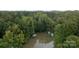 Aerial view of a lake and boathouse surrounded by lush greenery at 463 Lake Wylie Rd, Belmont, NC 28012