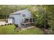 Exterior of the home featuring a deck, screened porch, and beautiful yard at 463 Lake Wylie Rd, Belmont, NC 28012