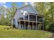 Rear exterior view of the home showcasing a deck, screened porch, and backyard at 463 Lake Wylie Rd, Belmont, NC 28012