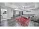 Finished basement with gray vinyl floors, a red rug, and plenty of seating at 463 Lake Wylie Rd, Belmont, NC 28012