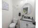 Stylish bathroom with a gray vanity, decorative mirror, and elegant fixtures at 463 Lake Wylie Rd, Belmont, NC 28012